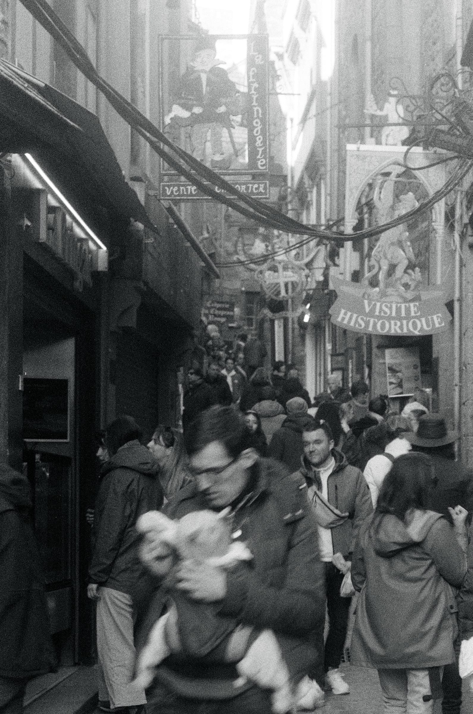 Crowded medieval street, France, motion blur, black and white