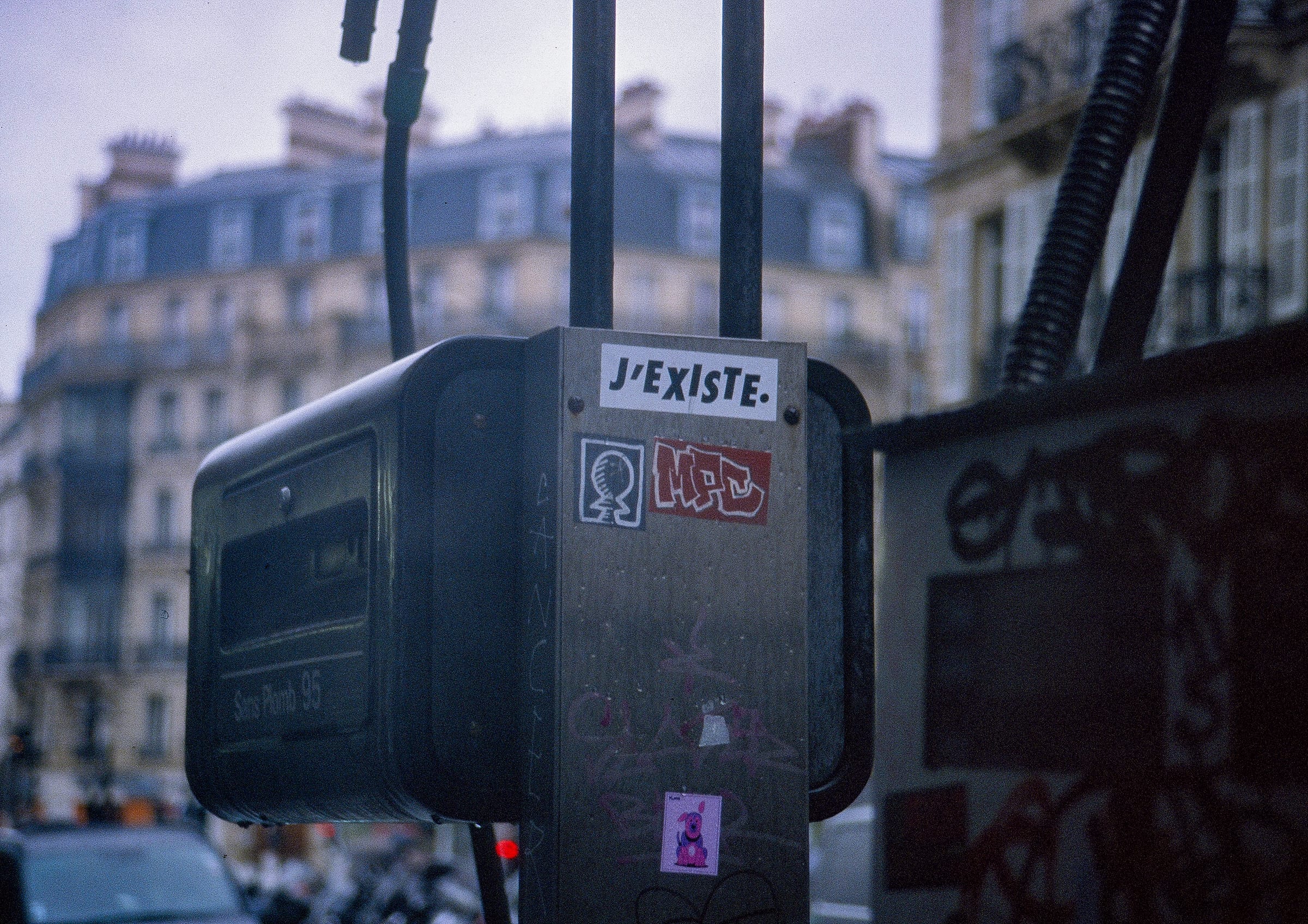 J'existe street sticker, Haussmann facade, Paris