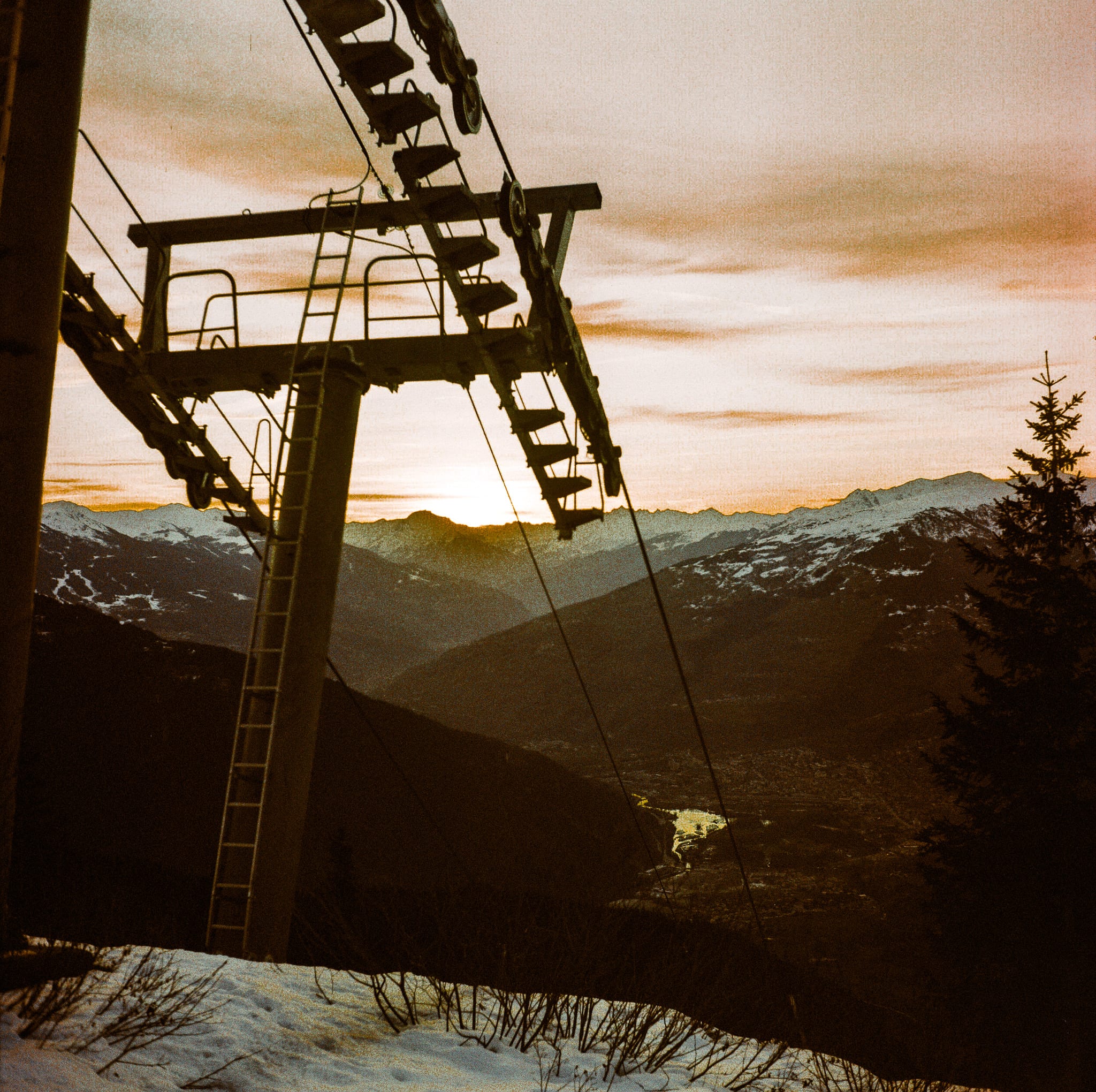 Ski lift silhouette at alpine sunset